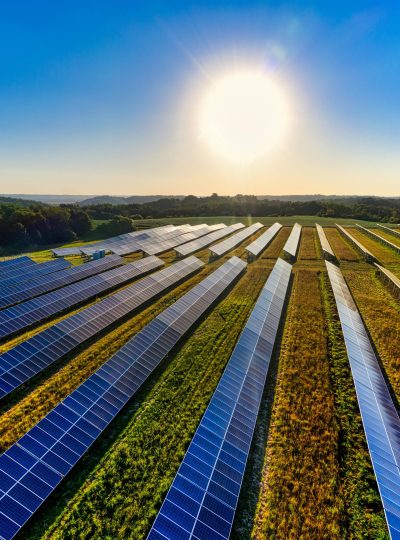 Aerial view of a solar farm in Red Wing, MN, with solar panels harnessing the sun's energy.